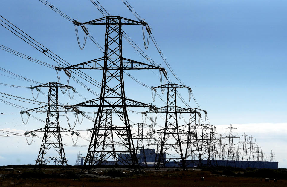 Electricity pylons run across Romney Marsh in Kent from Dungeness nuclear power station. Ofgem has confirmed an 80.06 percent rise in the energy price cap, sending the average household's yearly bill from GBP 1,971 to GBP 3,549 from October. Picture date: Friday August 26, 2022.