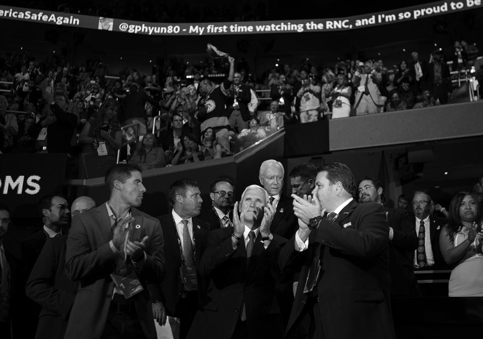 <p>Indiana Gov. Mike Pence claps while listening to speakers at the Republican National Convention. (Photo: Khue Bui for Yahoo News)</p>