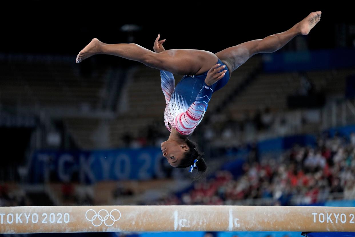 Simone Biles performs on the balance beam during the artistic gymnastics women's apparatus final at the 2020 Summer Olympics, on Tuesday, Aug. 3, 2021, in Tokyo, Japan. (AP Photo/Ashley Landis)