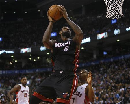 Nov 29, 2013; Toronto, Ontario, CAN; Miami Heat forward LeBron James (6) goes up to make a basket as Toronto Raptors guard Kyle Lowry (7) looks on at the Air Canada Centre. Miami defeated Toronto 90-83. Mandatory Credit: John E. Sokolowski-USA TODAY Sports