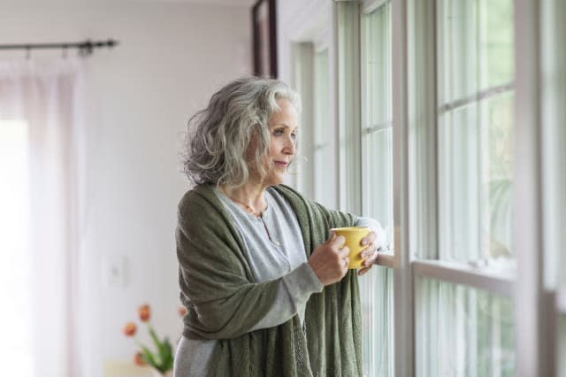 Senior woman looking out of window