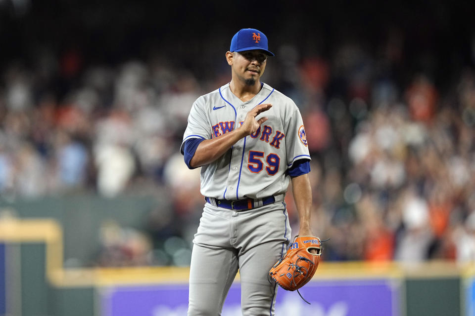 New York Mets starting pitcher Carlos Carrasco waits for a new baseball after giving up a home run to Houston Astros' Yordan Alvarez during the first inning of a baseball game Wednesday, June 22, 2022, in Houston. (AP Photo/David J. Phillip)