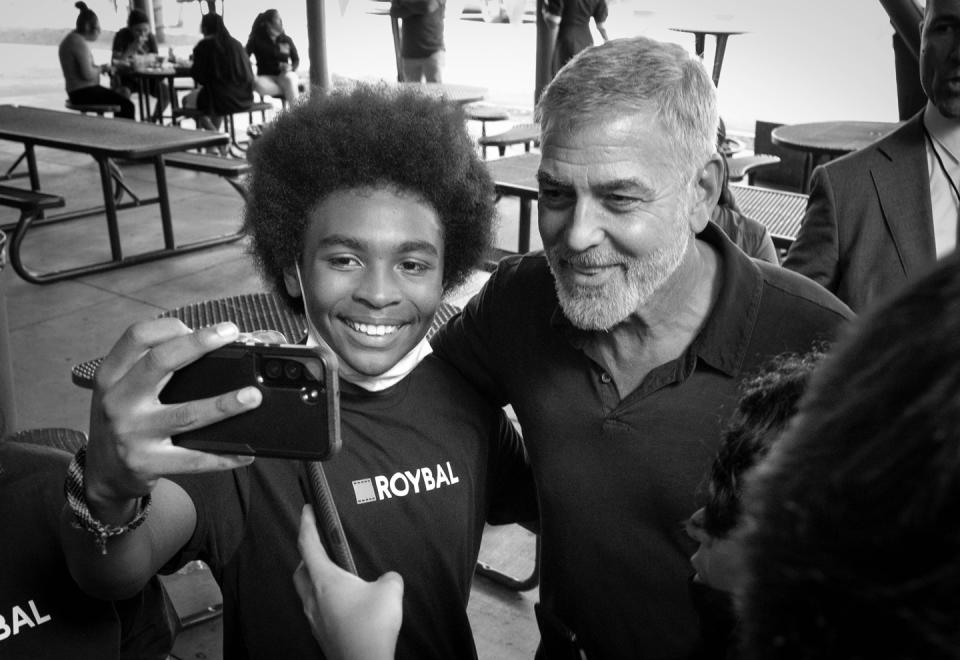 George Clooney, one of the actors behind the new Los Angeles magnet school focused on jobs in TV and film, took a selfie with a student during a visit last fall. (Getty Images)