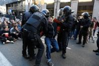 Catalan police dispersed students who blocked a street in Barcelona in protest at the trial of the former separatist leaders