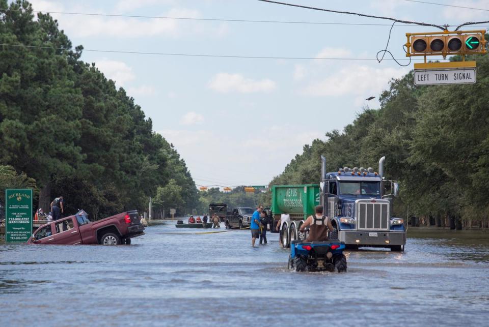 Rescuers and volunteers help evacuate a neighborhood along Eldridge Parkway flooded by waters released from Addicks Reservoir on Aug. 30, 2017, in Houston, added to flooding from Hurricane Harvey.
