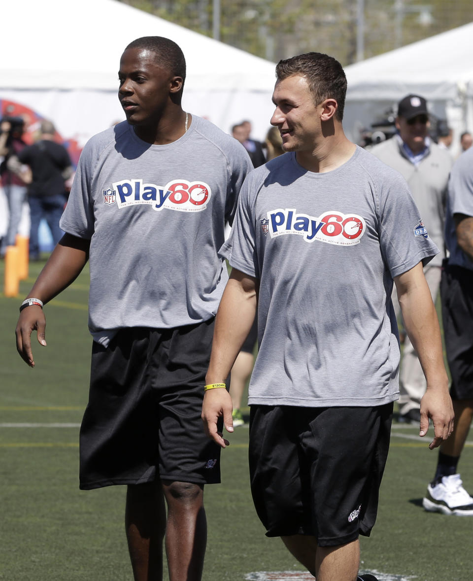 Louisville's Teddy Bridgewater, left, and Texas A&M's Johnny Manziel participate in an NFL football event in New York, Wednesday, May 7, 2014. The event was to promote Play 60, an NFL program which encourages kids to be active for a healthy life. (AP Photo/Seth Wenig)