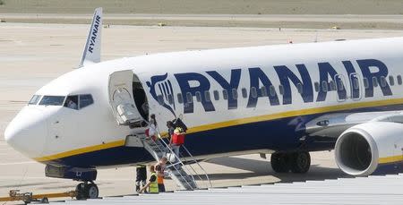 Passengers board a Ryanair plane parked at Girona airport, September 20, 2012. REUTERS/Albert Gea