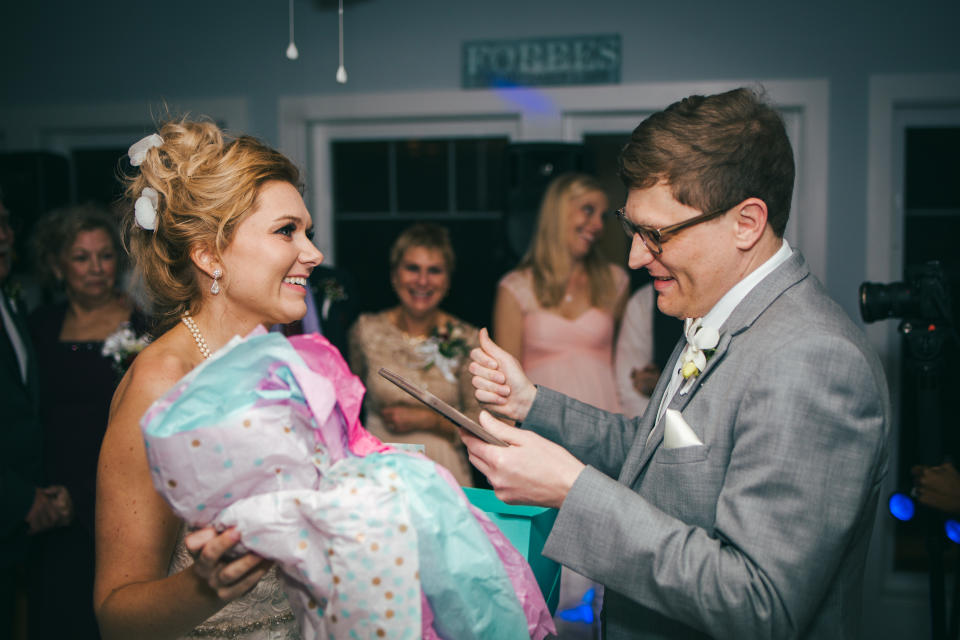 Jamie Forbes surprised her husband, Charlie, but gifting him a framed sonogram at their wedding to let him know he’s a dad-to-be. (Photo: James Brindley Wedding Photography)
