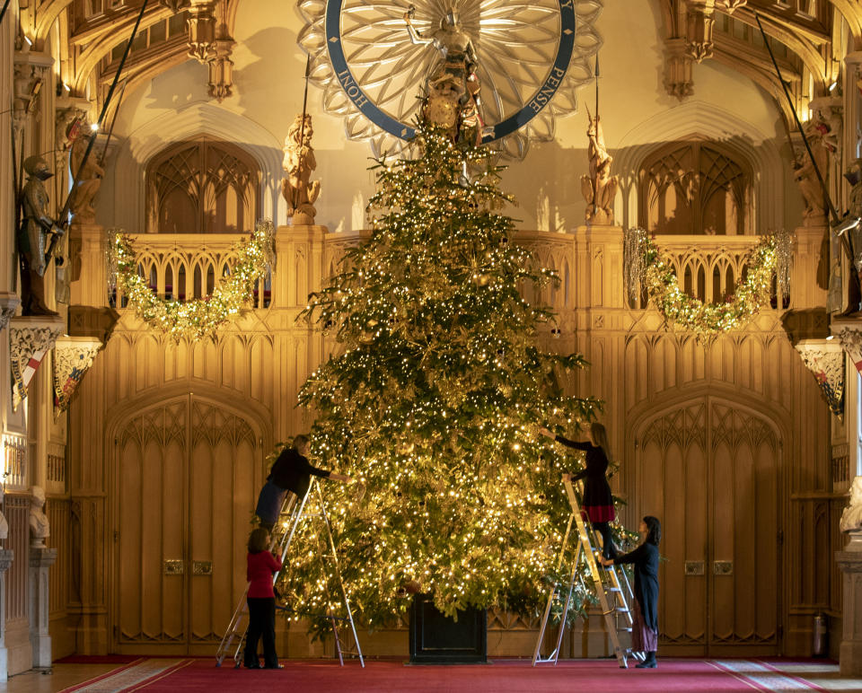 Final preparations are made to a 20ft Norman Fir Christmas tree in St George's Hall at Windsor Castle, Berkshire, which is being decorated for Christmas. (Photo by Steve Parsons/PA Images via Getty Images)