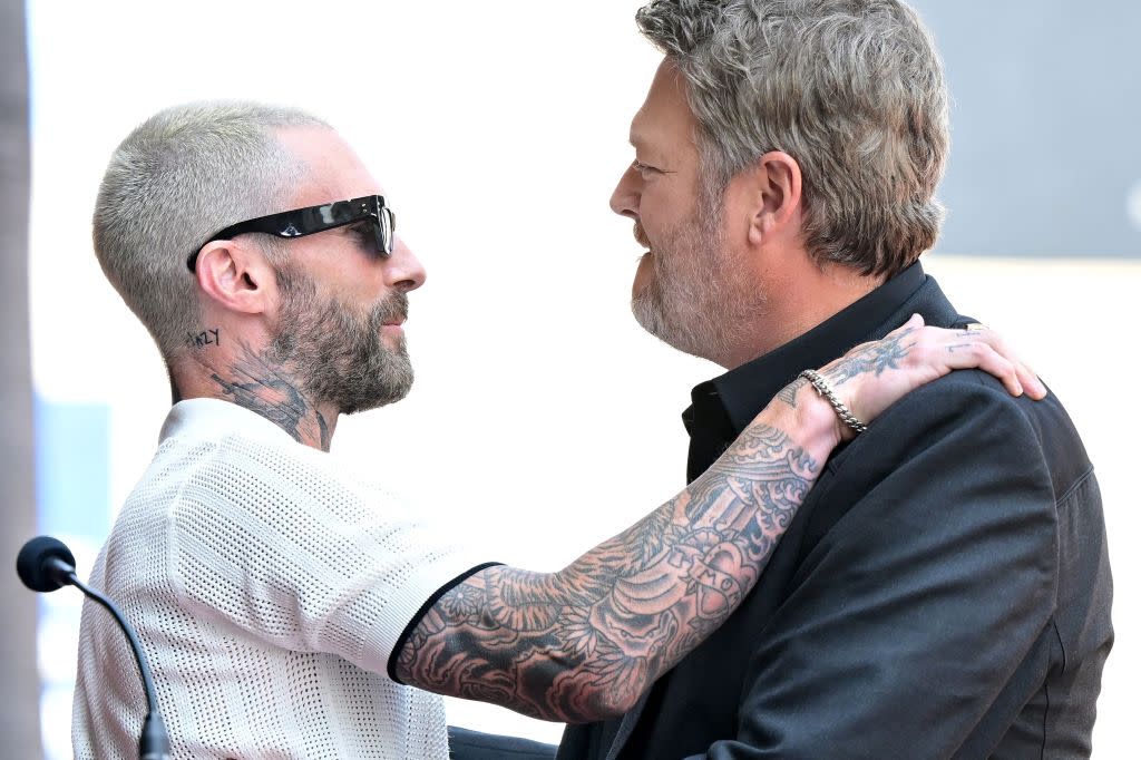 US country singer and television personality Blake Shelton (R) greets US singer Adam Levine pose during Shelton's Hollywood Walk of Fame Star ceremony, in Hollywood, California, on May 12, 2023. (Photo by Frederic J. BROWN / AFP) (Photo by FREDERIC J. BROWN/AFP via Getty Images)