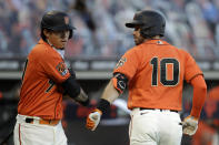 San Francisco Giants Evan Longoria (10) celebrates with Wilmer Flores after hitting a home run off Oakland Athletics' Jesus Luzardo in the first inning of a baseball game Friday, Aug. 14, 2020, in San Francisco. (AP Photo/Ben Margot)