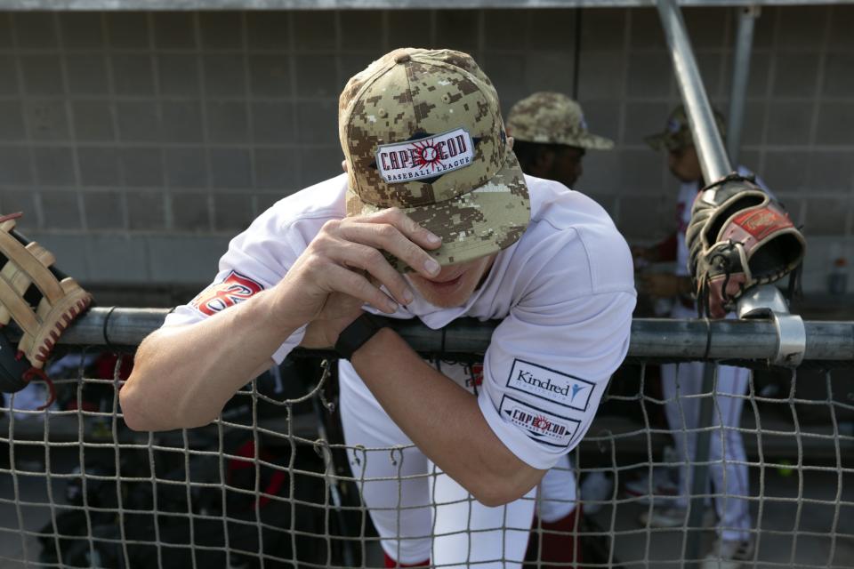 Bourne Braves' Sam Petersen stands in the dug out before a Cape Cod League baseball game against the Chatham Anglers, Wednesday, July 12, 2023, in Bourne, Mass. For 100 years, the Cape Cod League has given top college players the opportunity to hone their skills and show off for scouts while facing other top talent from around the country. (AP Photo/Michael Dwyer)