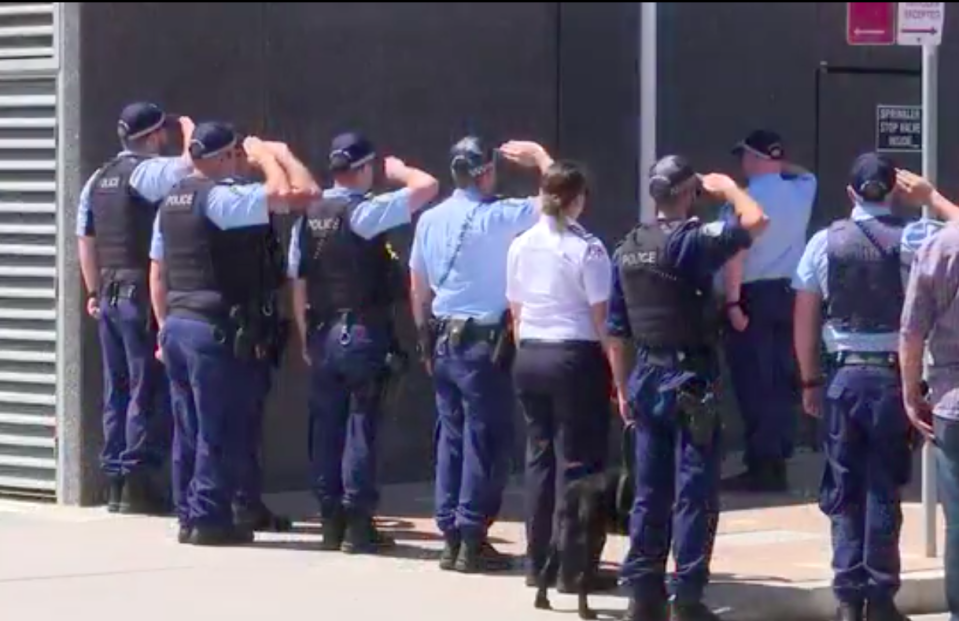 Officers pay their respects for their fallen colleague. Source: 7 News