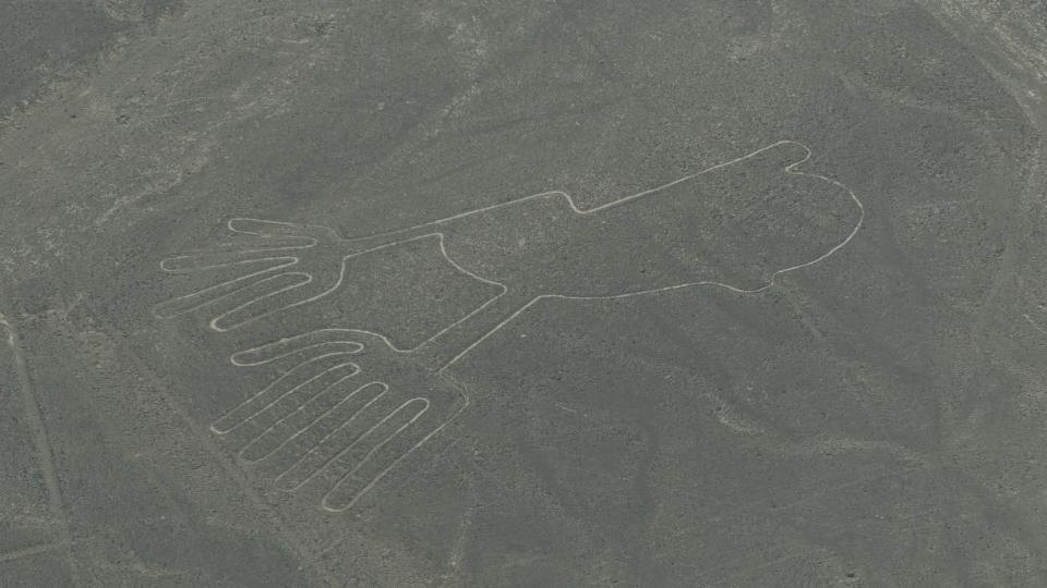 Aerial photo of Nazca lines in Peru. This geoglyph looks like a line drawing of a a pair of human hands.