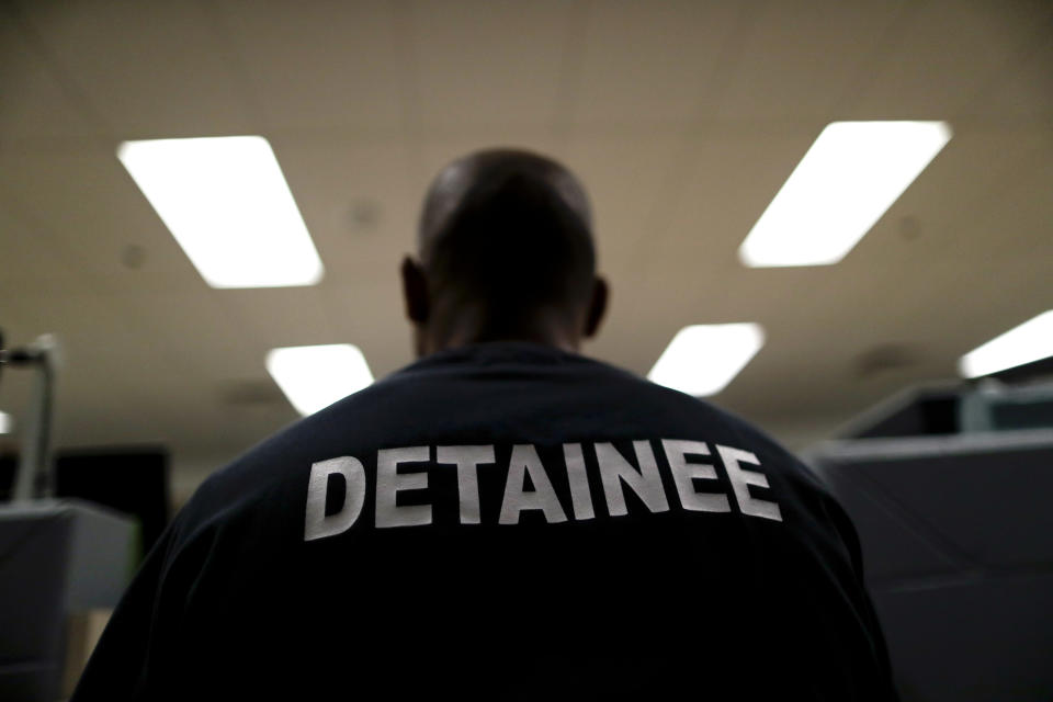 A detainee sits at the Otay Mesa Detention Center Wednesday, Aug. 23, 2017, in San Diego. The facility was at the center of the first big novel coronavirus outbreak at a U.S. immigration detention center in April 2020. (AP Photo/Gregory Bull)
