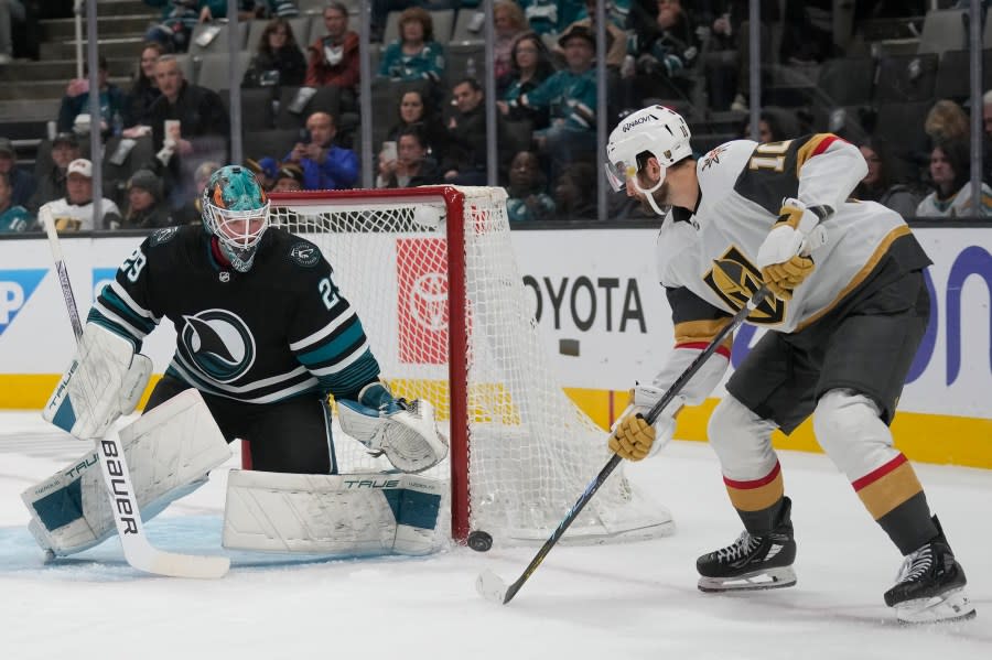 San Jose Sharks goaltender Mackenzie Blackwood, left, defends against a shot attempt by Vegas Golden Knights center Nicolas Roy during the second period of an NHL hockey game in San Jose, Calif., Monday, Feb. 19, 2024. (AP Photo/Jeff Chiu)