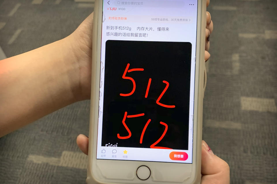 In this Dec. 24, 2019 photo, a post from a vendor offering Tylox for sale on Xianyu, Alibaba's online second-hand marketplace, is seen on a smartphone in Shanghai, China. Officially, pain pill addiction is an American problem, not a Chinese one. But people in China have fallen into opioid abuse the same way many Americans did, through a doctor's prescription. And despite China's strict regulations, online trafficking networks, which facilitated the spread of opioids in the U.S., also exist in China. Tylox pills are known on the black market as 512s, after the number marked on their side. The text of the ad reads "Newly arrived 512g cell phones, loaded with blockbuster movies, who understands come. If interested, leave me a message!". (AP Photo/Erika Kinetz)