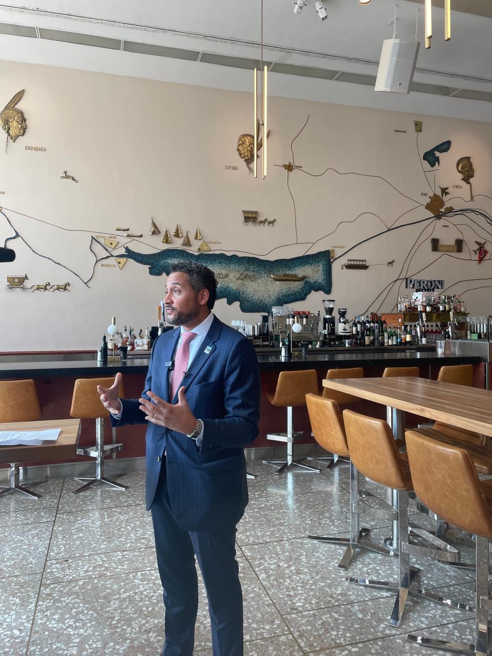 New York Secretary of State Robert J. Rodriguez visits Nostro Restobar and Lounge, one of the businesses now housed in the former Oneida National Bank building.
