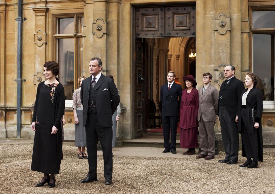 This undated publicity photo provided by PBS shows, from left, Elizabeth McGovern as Lady Grantham, Hugh Bonneville as Lord Grantham, Dan Stevens as Matthew Crawley, Penelope Wilton as Isobel Crawley, Allen Leech as Tom Branson, Jim Carter as Mr. Carson, and Phyllis Logan as Mrs. Hughes, from the TV series, "Downton Abbey." It was reliably delicious and also pretty deadly in its third season, which began last January. Lovely Lady Sybil died in childbirth. Then, in the season conclusion, Matthew Crawley, heir to Downton and Lady Mary's beloved, perished in a car crash, leaving her a widowed mother. Hankies were sopping as viewers faced a long wait for Season 4. (AP Photo/PBS, Carnival Film & Television Limited 2012 for MASTERPIECE, Nick Briggs)