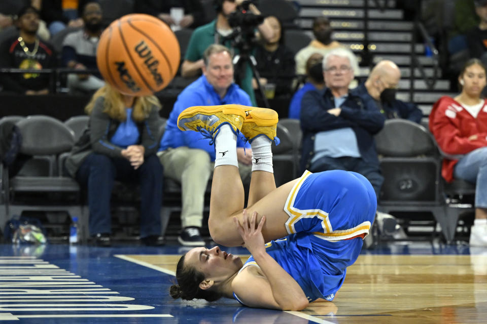 UCLA guard Gina Conti rolls on the court after a shot attempt against Arizona during the first half of an NCAA college basketball game in the quarterfinal round of the Pac-12 women's tournament Thursday, March 2, 2023, in Las Vegas. (AP Photo/David Becker)