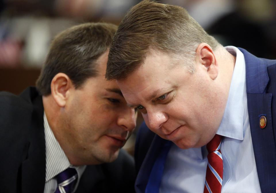FILE - State Reps. Jason Saine, right, and John Bell confer as the N.C. General Assembly reconvenes for a special session on Dec. 13, 2016, in Raleigh, N.C. With abortion restrictions, looser gun rules and deeper tax reductions likely in the balance, North Carolina Republican lawmakers and Democratic Gov. Roy Cooper are fighting in the campaign trenches over whose policy agenda will win out in Cooper's final two years in office. (Chris Seward/The News & Observer via AP, File)