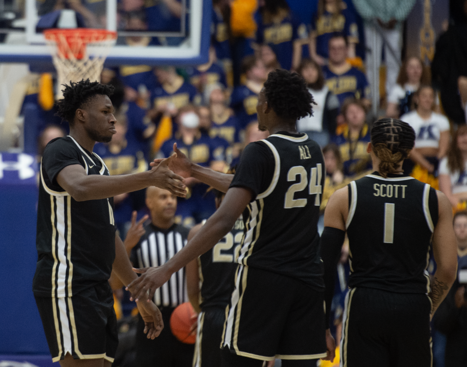 Akron's Sammy Hunter and Ali Ali (24) react to the Zips approaching victory over Kent State on Friday at the MAC Center.