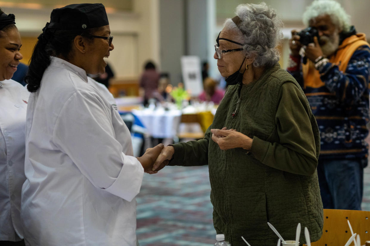 Sandra McWorter Marsh, at right, greets a student of the Washburne Culinary & Hospitality Institute at Chicago's Kennedy-King College in February 2023. Students prepared recipes gleaned from several of the more than 1,7000 cookbooks donated by Marsh, 82, for a luncheon honoring the gift.
