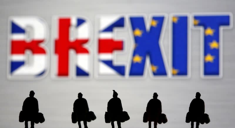 FILE PHOTO: Small toy figures are seen in front of a Brexit logo in this illustration picture