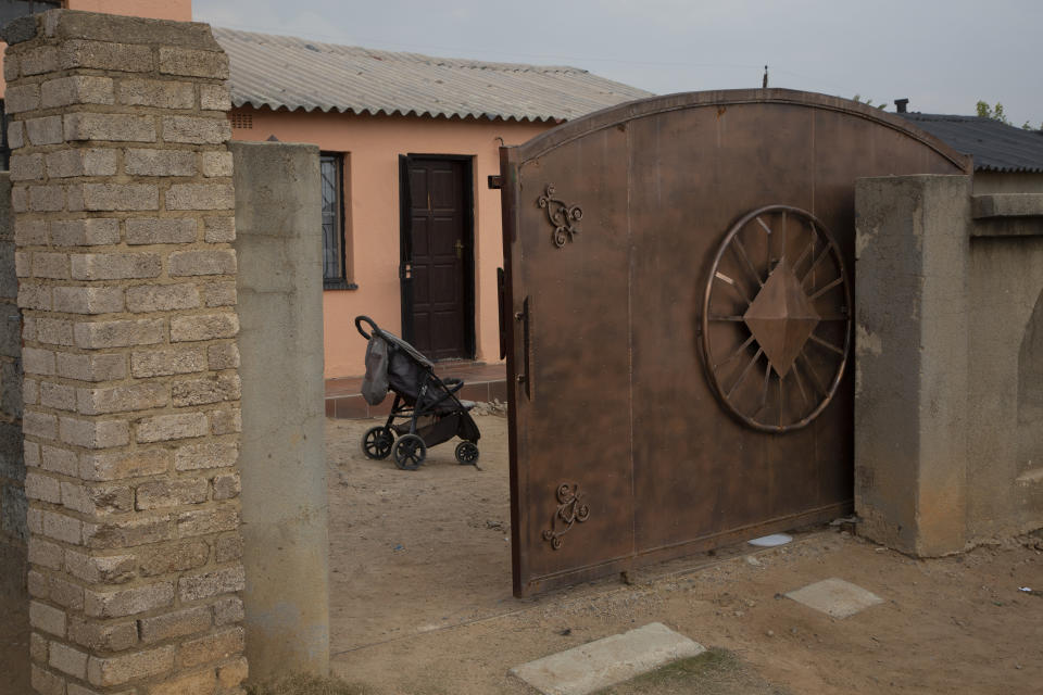 A pram stands outside the home of Gosiame Thamara Sithole in Tembisa, near Johannesburg, Thursday, June 10, 2021. South Africa is gripped by a mystery over if the woman, Sithole, has, as has been claimed, given birth to 10 babies in what would be a world-first case of decuplets. The South African government said Thursday it is still trying to verify the claim. (AP Photo/Denis Farrell)