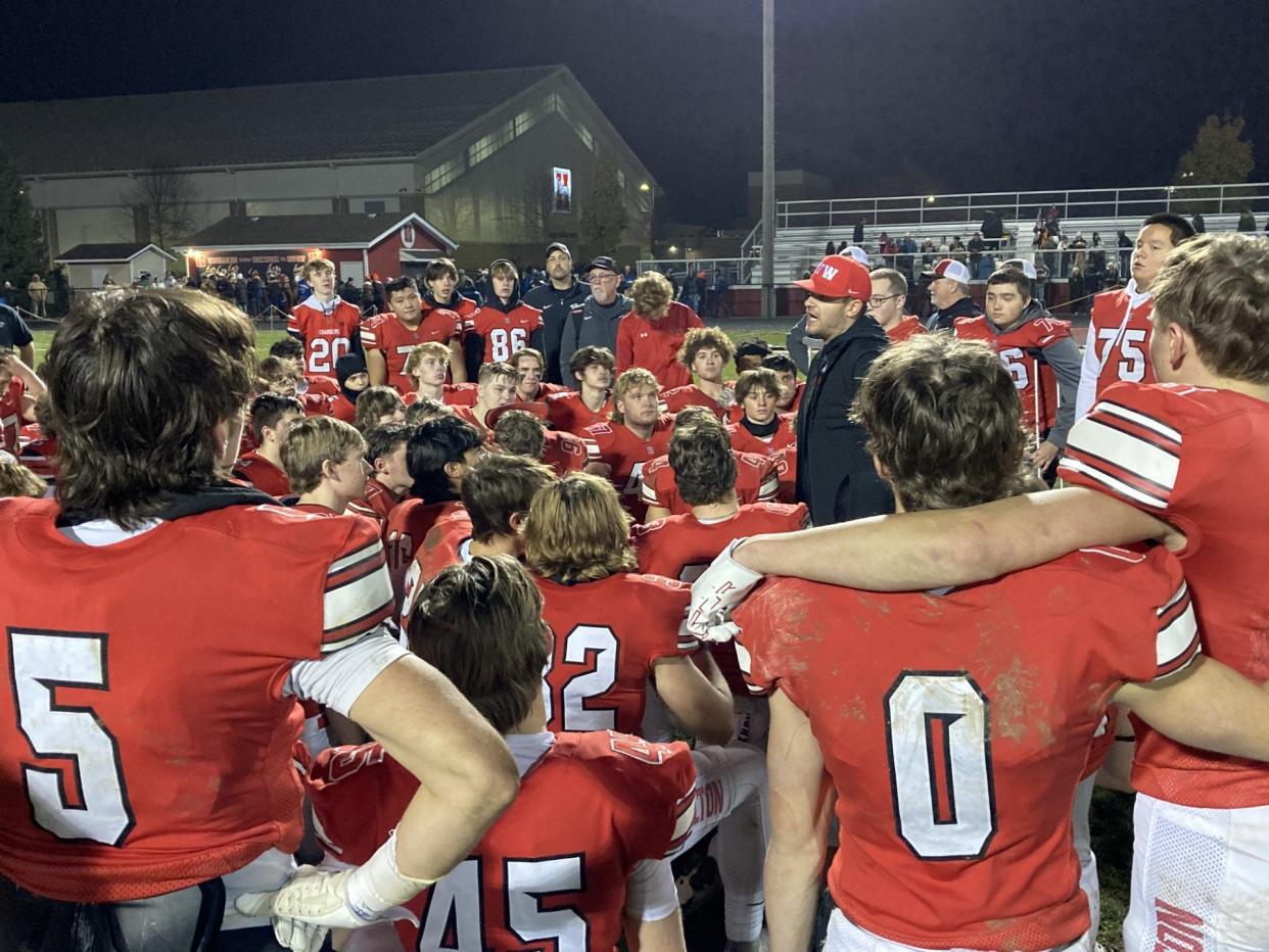 Sussex Hamilton head football coach Justin Gumm (center in red hat) speaks to his players after the Chargers defeated Verona in Level 3 of the WIAA Division 1 playoffs, 26-16, on Nov. 3, 2023 in Sussex.