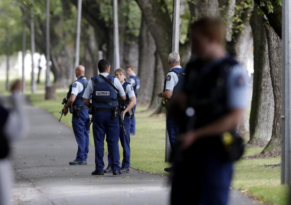 Police keep watch at a park across the road from a a mosque in central Christchurch, New Zealand, Friday, March 15, 2019. Multiple people were killed in mass shootings at two mosques full of people attending Friday prayers, as New Zealand police warned people to stay indoors as they tried to determine if more than one gunman was involved. (AP Photo/Mark Baker)