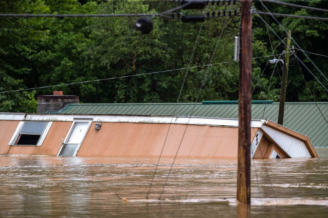 Homes are flooded by Lost Creek, Ky., on Thursday, July 28, 2022.