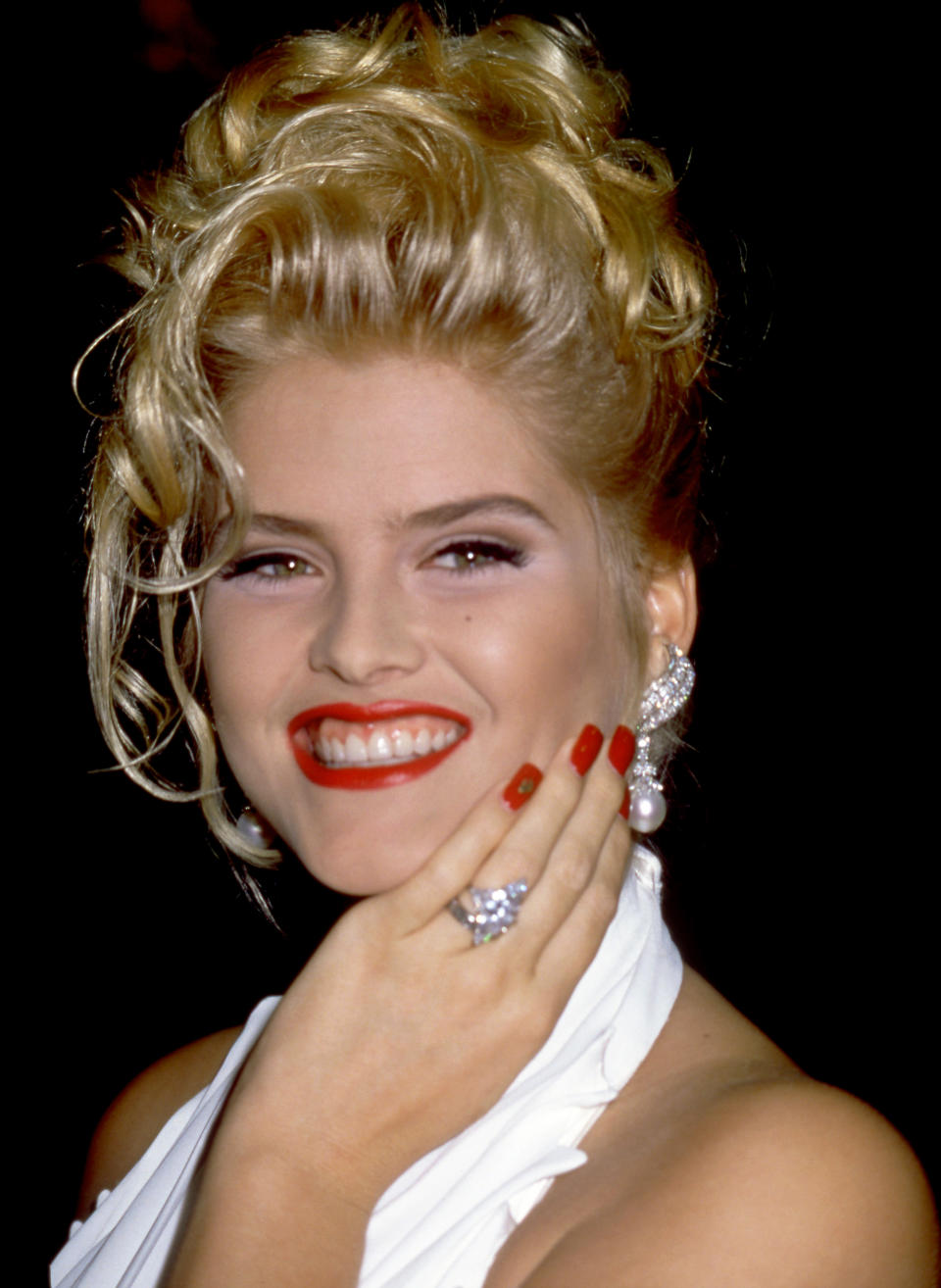 Anna Nicole Smith smiling and showing off her wedding ring