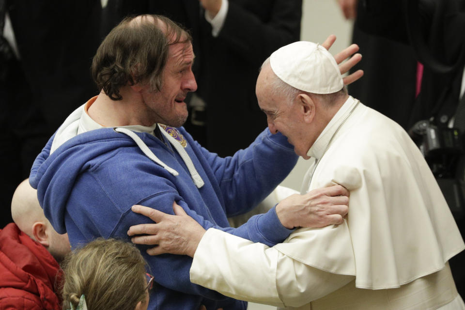 Pope Francis greets a man during his weekly general audience, at the Pope Paul VI hall, at the Vatican, Wednesday, Feb. 19, 2020. (AP Photo/Andrew Medichini)