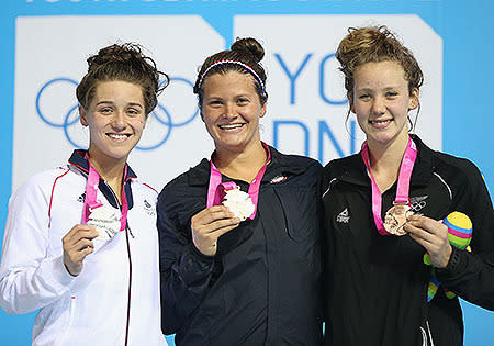 Gold medalist Clara Smiddy of the United States (C), silver medalist Jessica Fullalove of Great Britain (L) and bronze medalist Bobbi Gichard of New Zealand (R) pose for photo after winning the Women's 100m Backstroke Final on day two of Nanjing 2014 Summer Youth Olympic Games.