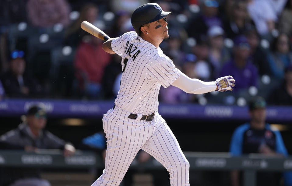 Colorado Rockies' Yonathan Daza follows the flight of his sacrifice fly that drove in a run off Miami Marlins relief pitcher Tanner Scott in the eighth inning of a baseball game Monday, May 30, 2022, in Denver. (AP Photo/David Zalubowski)