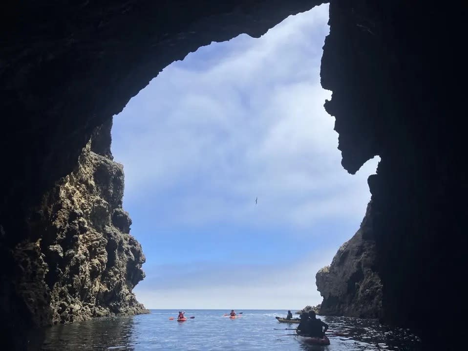 Kayakers paddle through sea caves on the Channel Islands.