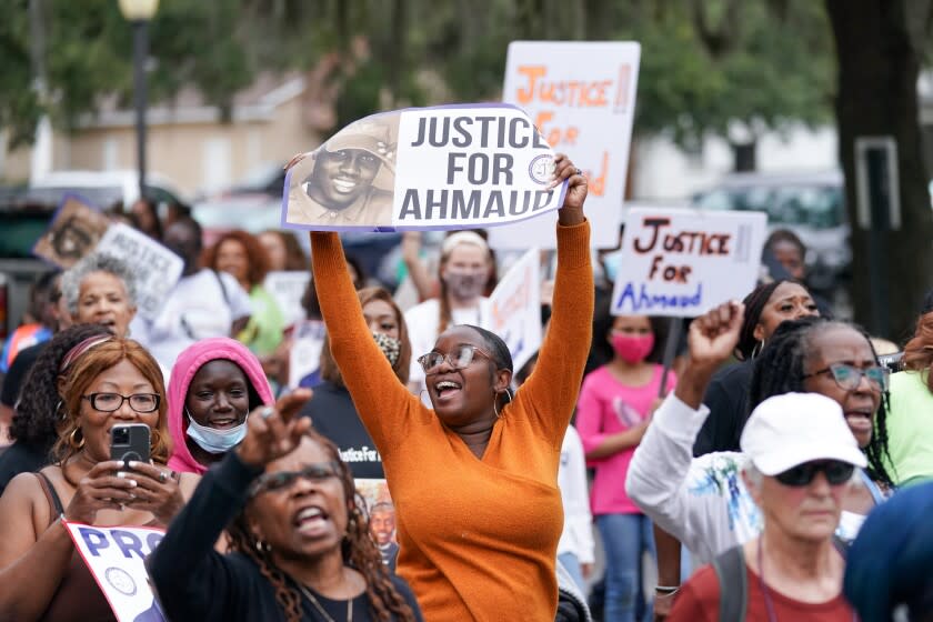 BRUNSWICK, GA - NOVEMBER 18: Demonstrators march near the Glynn County Courthouse after the adjournment of daily court proceedings in the trial for the killers of Ahmaud Arbery on November 18, 2021 in Brunswick, Georgia. Greg McMichael, his son Travis McMichael, and a neighbor, William "Roddie" Bryan are charged with the February, 2020 slaying of 25-year-old Ahmaud Arbery. (Photo by Sean Rayford/Getty Images)