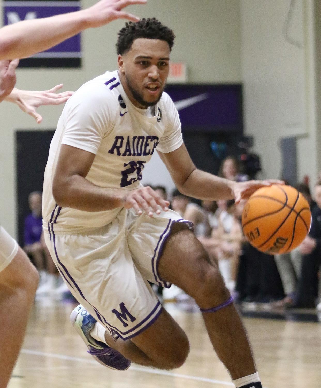 Mount Union's Christian Parker drives to the basket during a game against Marietta on Jan. 11.