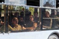 Buses carrying Ukrainian Azovstal service members leave Mariupol