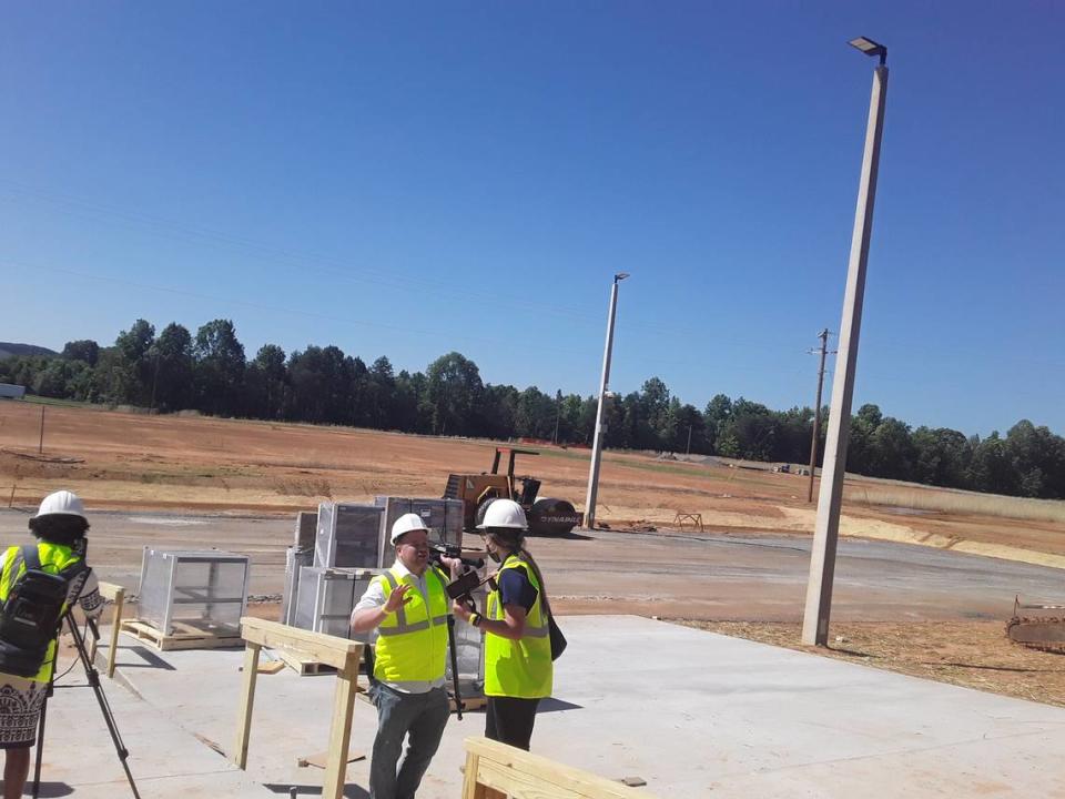 Workers are shown outside the Catawba Indian Nation’s soon-to-open 500-slot “pre-launch” gambling facility off Interstate 85 in Kings Mountain, N.C., on Thursday, June 17, 2021. A larger, “temporary” casino facility will be built on the land in the background.