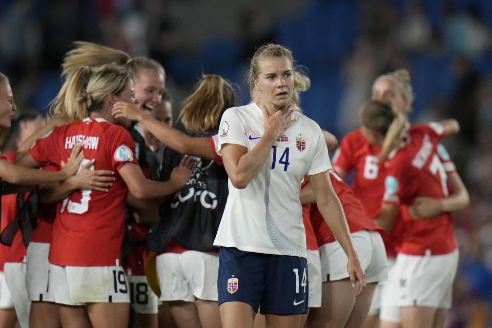 FILE - Norway's Ada Hegerberg, center, reacts as the Austrian players celebrate in the background, at the end of the Women Euro 2022 group A soccer match between Austria and Norway at Brighton & Hove Community Stadium in Brighton, England, Friday, July 15, 2022. Austria won 1-0 to advance to the quarterfinals. (AP Photo/Alessandra Tarantino, File)