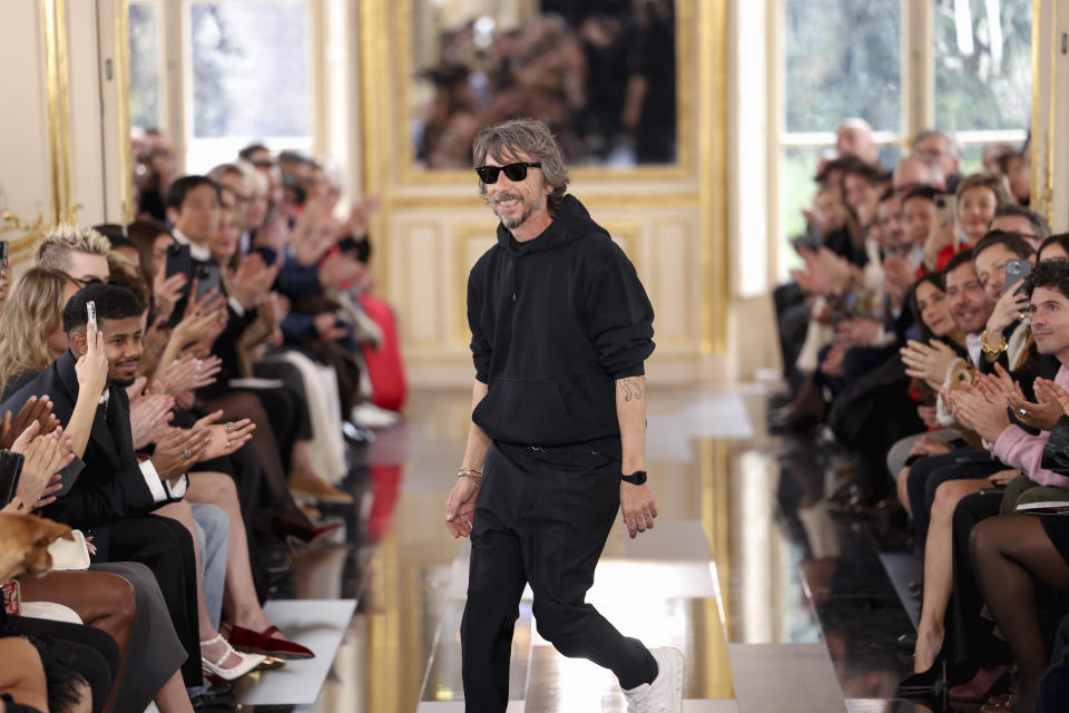 Designer Pier Paolo Piccioli accepts applause after the Valentino Fall/Winter 2024-2025 ready-to-wear collection presented Sunday, March 3, 2024 in Paris. (Photo by Vianney Le Caer/Invision/AP)