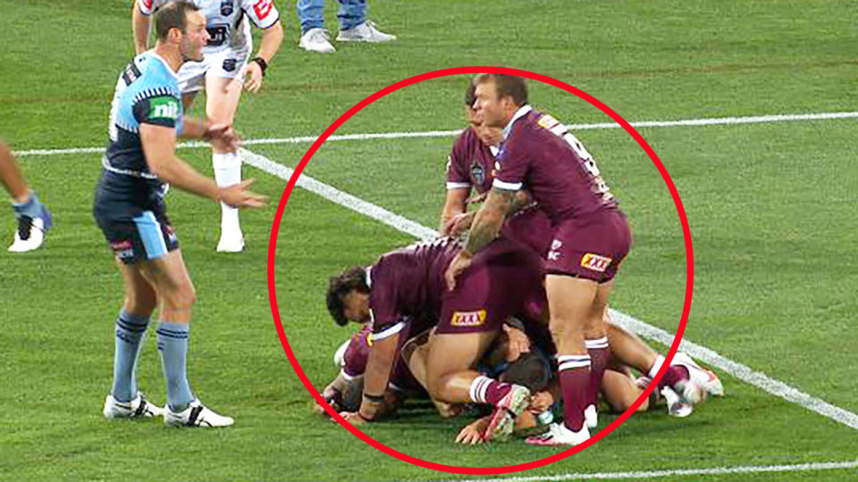 Queensland players, pictured here laying on the tackle in the dying stages of the State of Origin opener.