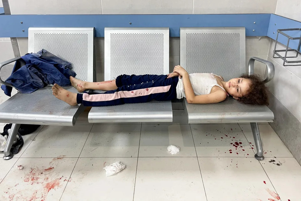 A child lies on a bench inside Shifa Hospital in Gaza City on Oct. 23. (Mohammed Al-Masri/Reuters)