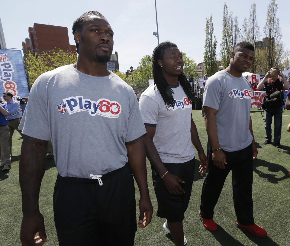 South Carolina's Jadeveon Clowney, left, Clemson's Sammy Watkins, center, and Buffalo's Khalil Mack participate in an NFL event in New York, Wednesday, May 7, 2014. The event was to promote Play 60, an NFL program which encourages kids to be active for a healthy life. (AP Photo/Seth Wenig)