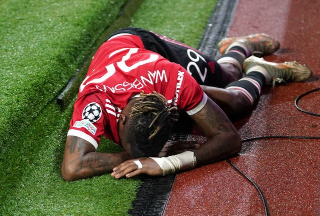 Aaron Wan-Bissaka lays on the ground