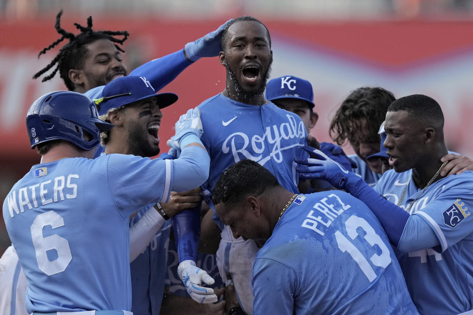 Kansas City Royals' Samad Taylor, center, celebrates with teammates after hitting a single to drive in the winning run during the ninth inning of a baseball game against the Los Angeles Angels Saturday, June 17, 2023, in Kansas City, Mo. The Royals won 10-9. (AP Photo/Charlie Riedel)