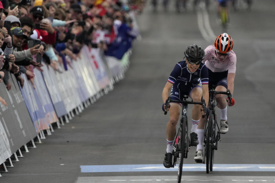 Eglantine Rayer of France, left, edges out Nienke Vinke of Netherlands to take second place in the junior women's road race at the world road cycling championships in Wollongong, Australia, Saturday, Sept. 24, 2022. (AP Photo/Rick Rycroft)