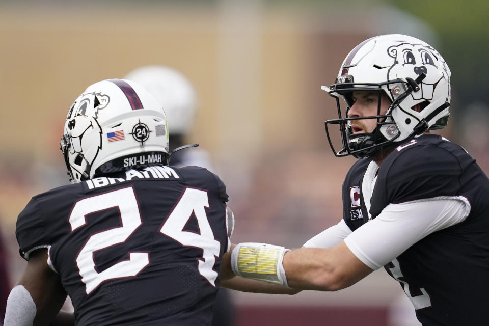 Minnesota quarterback Tanner Morgan, left, hands the ball off to running back Mohamed Ibrahim, right, before an NCAA college football game against Western Illinois, Saturday, Sept. 10, 2022, in Minneapolis. (AP Photo/Abbie Parr)